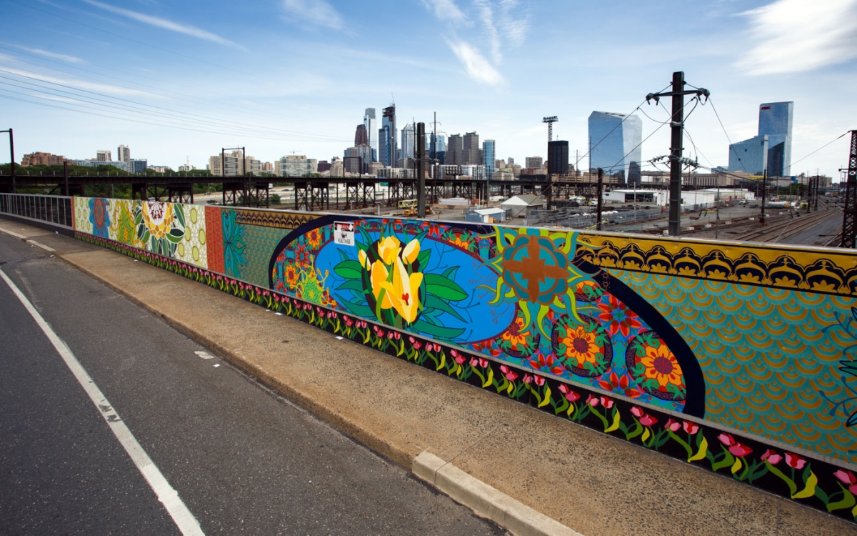 A mural titled Sing Because it is Heard by Betsy Casañas at the Spring Garden Street Bridge