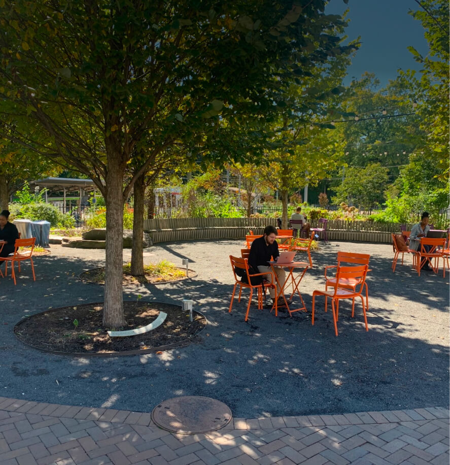 People sitting outside at the 40th St Trolley Portal Garden during the summer