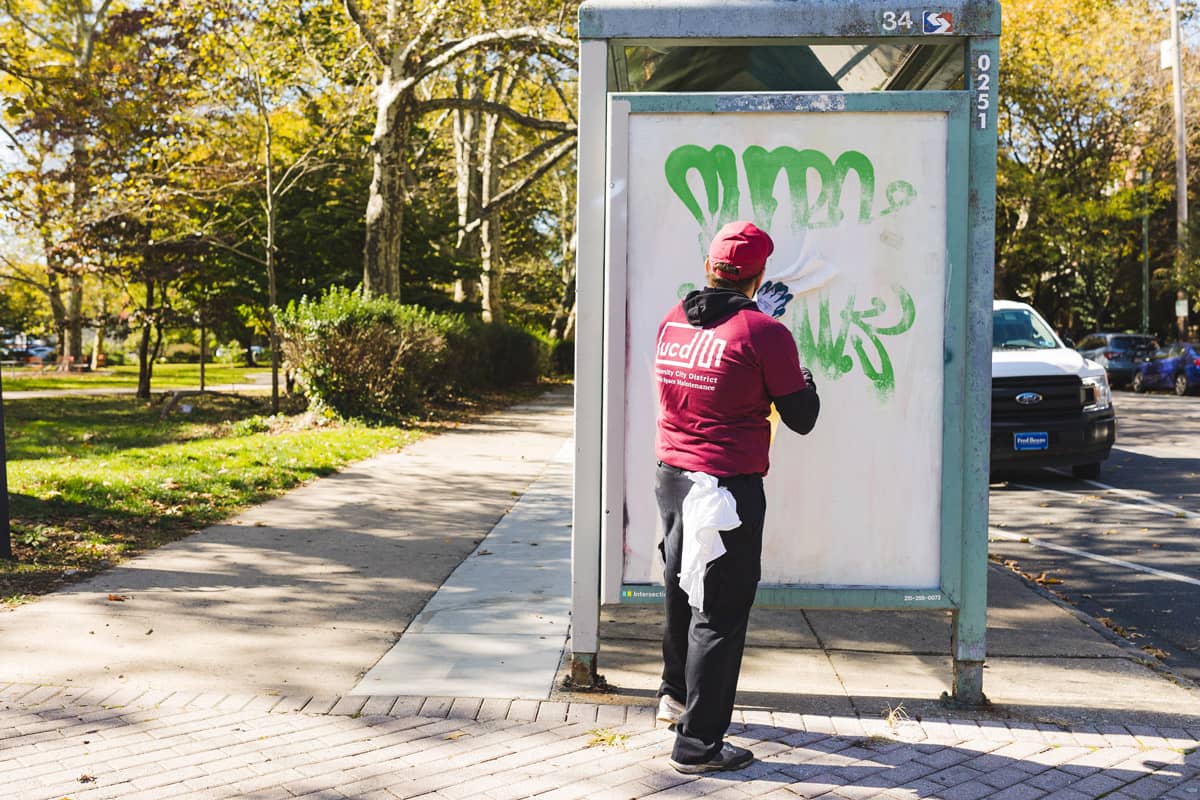 University City Public Space employee cleaning graffiti