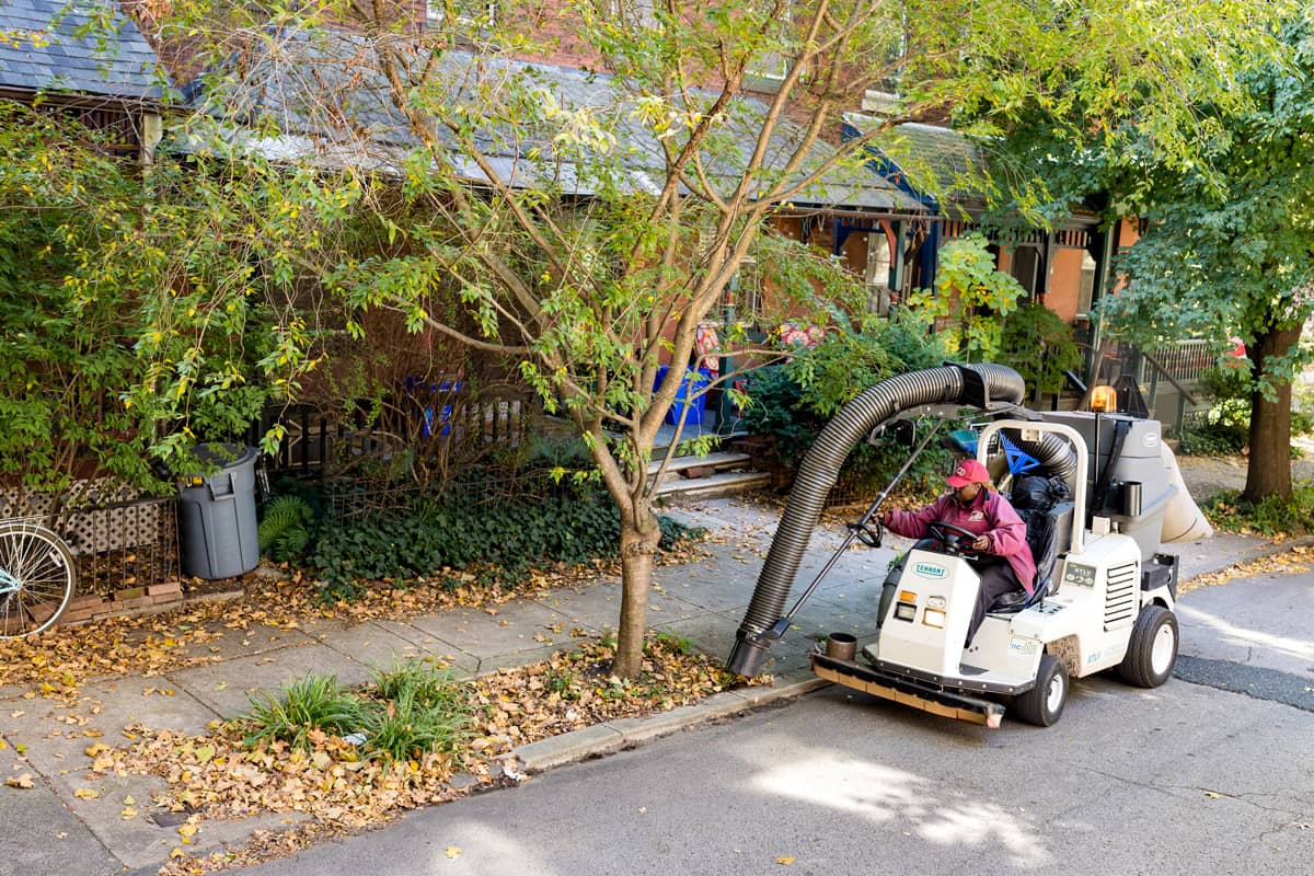 University City Public Space Maintenance person using street cleaning machine