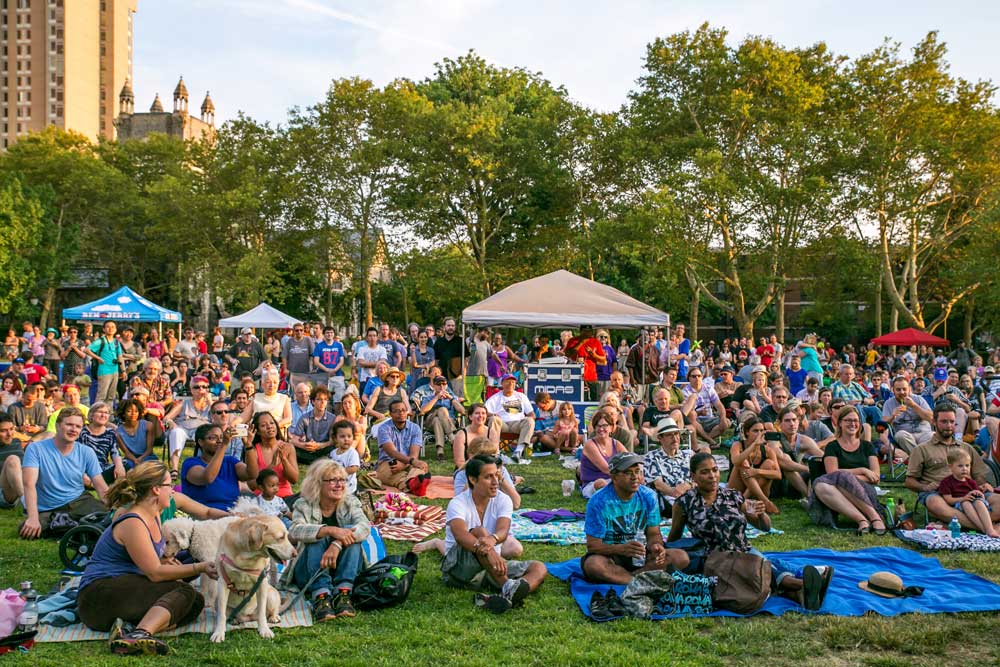 photo of a large crowd of community members gathered at an outdoor concert.