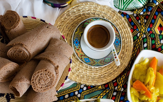 A spread of Alif Brew's delicious food, including coffee, bread, and pickled veggies.