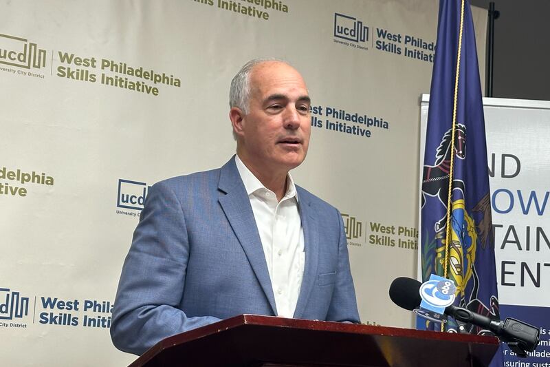 Bob Casey speaks at a podium, wearing a white button up and blue blazer.