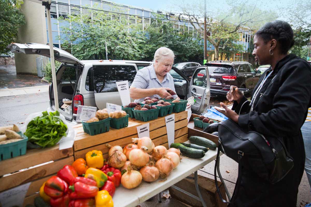 Community members shop for fresh produce at the Clark Park Farmers' market