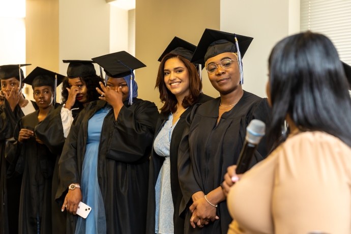 Skills Initiative graduates in caps and gowns at their graduation ceremony.