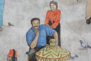 An illustration of Amare Solomon, original owner of Dahlak, from the mural The Heart of Baltimore Avenue