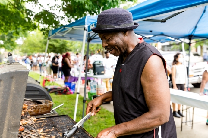 A vendor grills chicken skewers in Cedar Park during the Baltimore Avenue Dollar Stroll