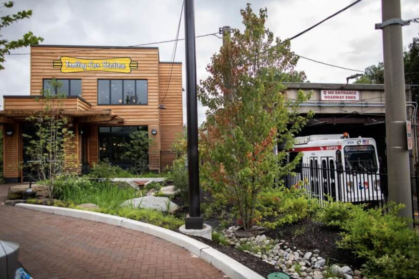 Trolley Portal Gardens with Renata's Restaurant building and a trolley in the background