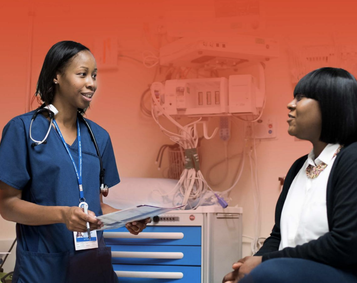 A Skills Initiative graduate on the job working as a medical assistant in a hospital room.