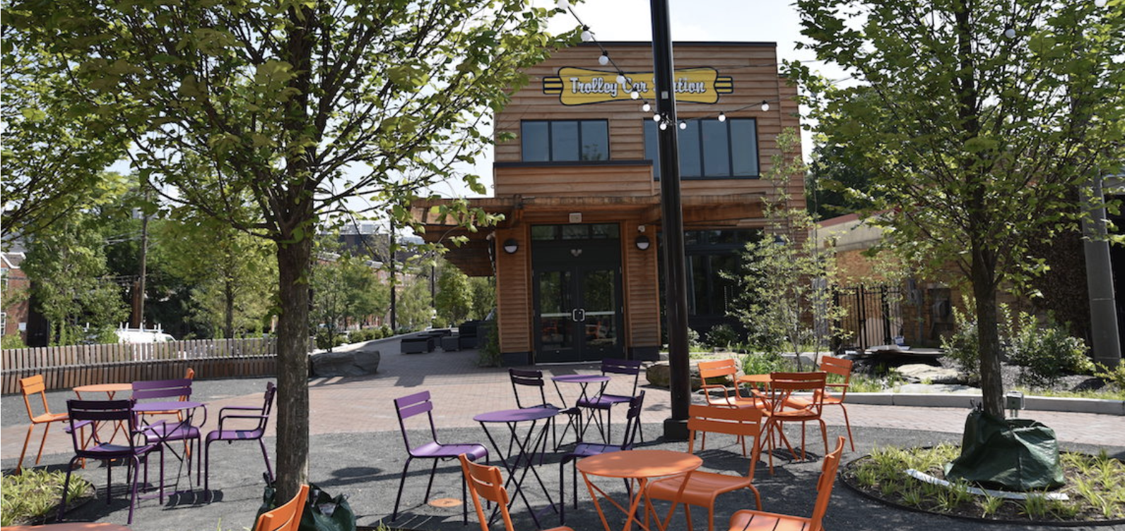 seating on a sunny day at Trolley Portal Gardens with Renata's Kitchen in the background