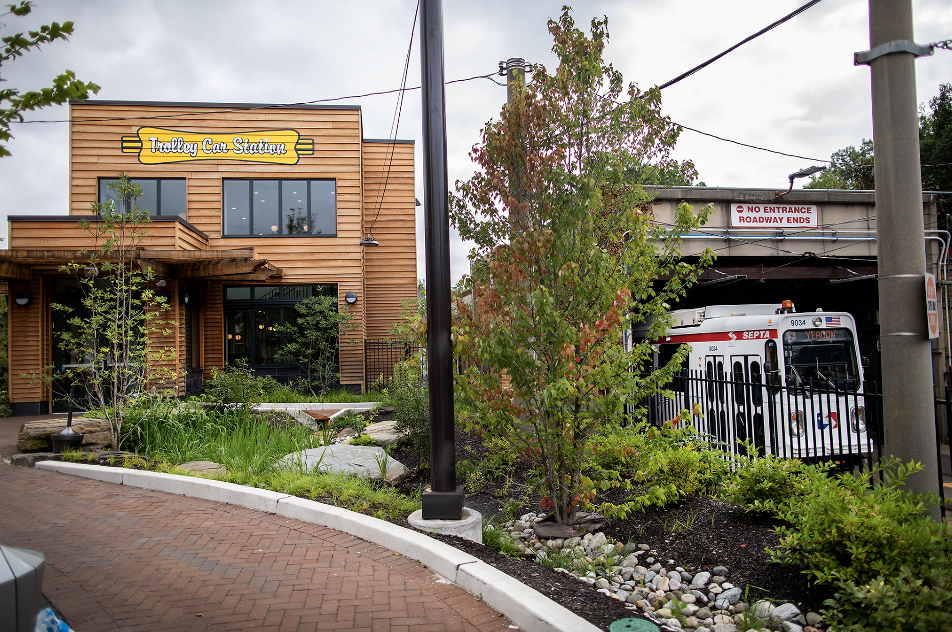 Septa trollies emerging from the 40th Street portal into the new landscaped garden. A new cafe helps animate the space.