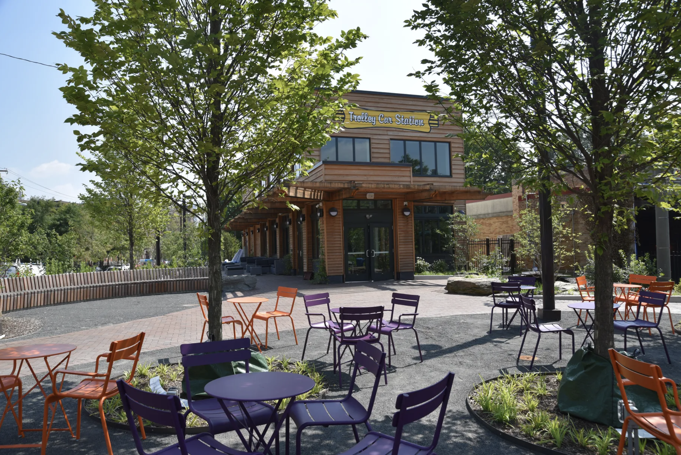 seating on a sunny day at Trolley Portal Gardens with Renata's Kitchen in the background