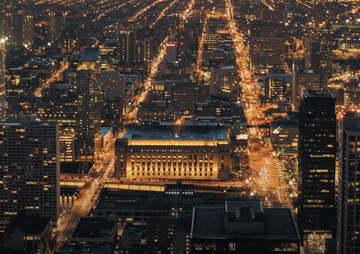 State of University City 2017 header. Features birds eye view of 30th st station lit up at night