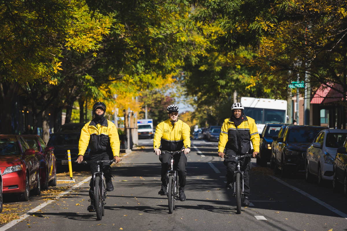 UCD Safety Ambassadors on bicycles patrolling the neighborhood.