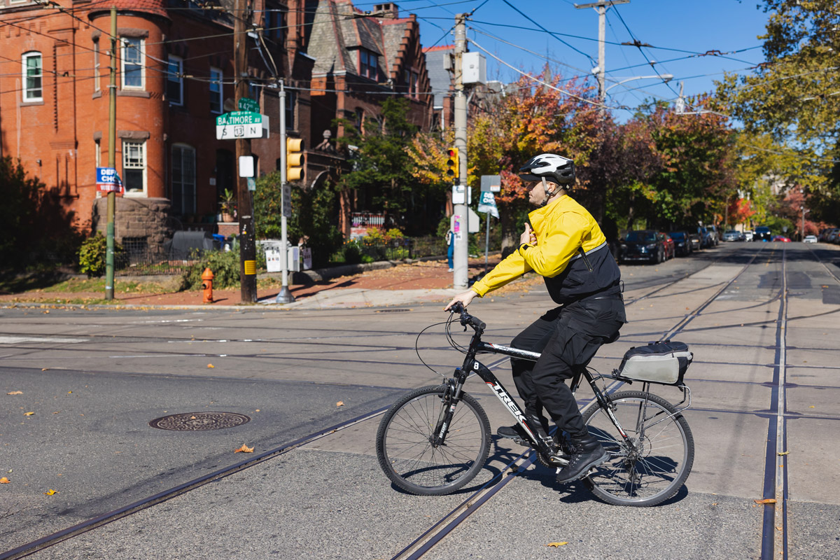 UCD Safety Ambassador on a bicycle patrolling the neighborhood.