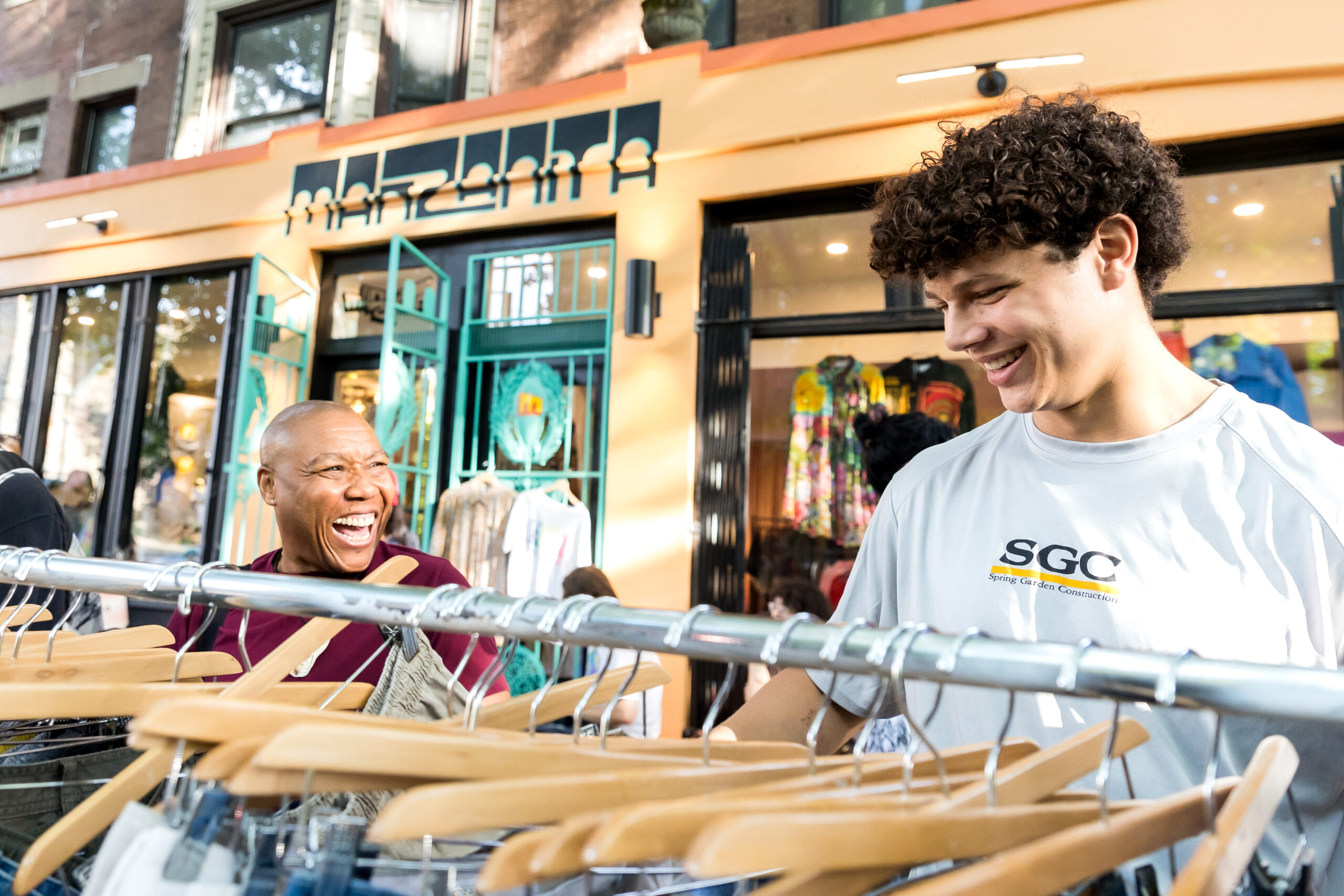 Two shoppers sharing a laugh outside of Manzanita during the Dollar Stroll.