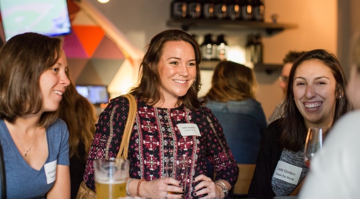 Three women enjoy drinks and networking during University City MIX