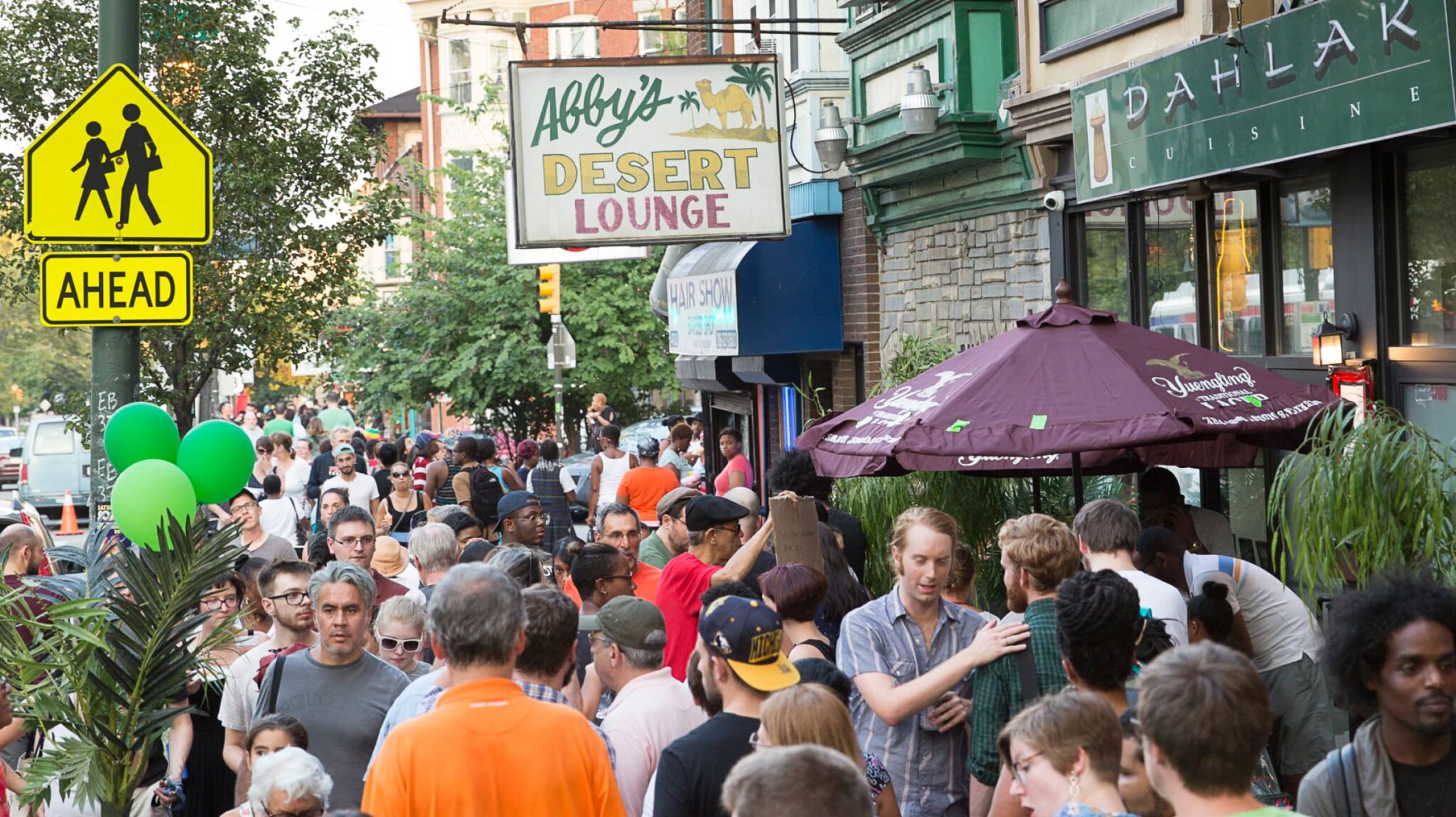 Large crowd of people outdoors at the Baltimore ave Dollar Stroll