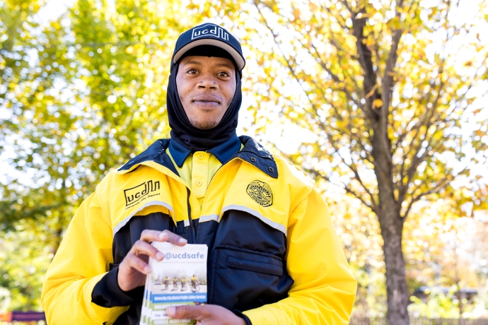 A UCD Safety Ambassador handing out materials in the community.